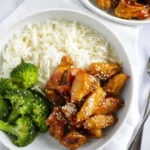 Plated bowl of Easy Teriyaki Chicken Recipe garnished with sesame seeds and scallions.
