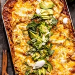 Stacked slices of saucy Beef Enchilada Casserole with melted cheese and fresh cilantro.
