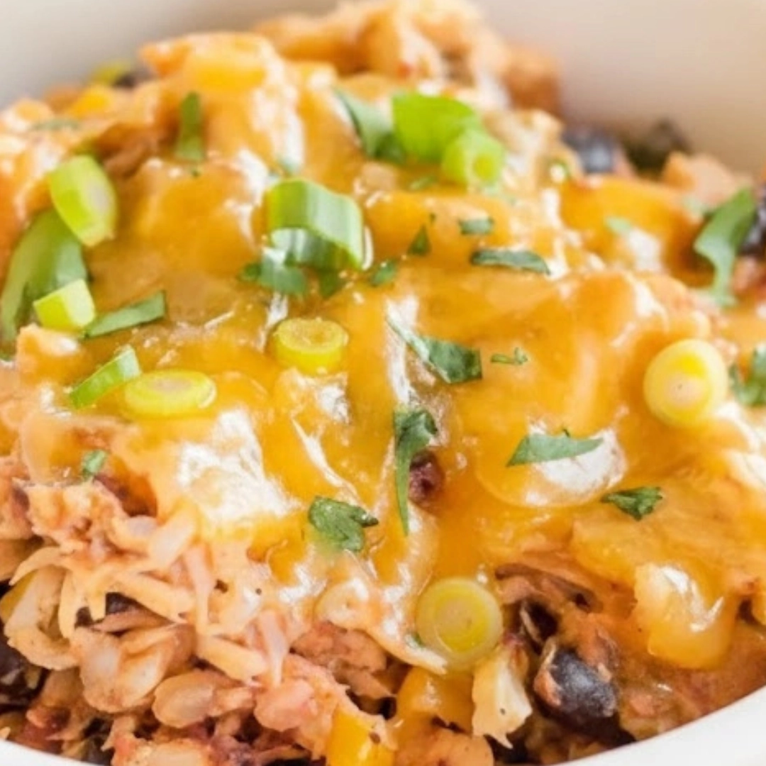 A generous bowl of Slow Cooker Chicken Burrito Bowls topped with avocado, cilantro, and sour cream. A generous bowl of Slow Cooker Chicken Burrito Bowls topped with avocado, cilantro, and sour cream.